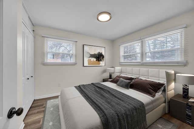 bedroom featuring dark hardwood / wood-style flooring and a closet