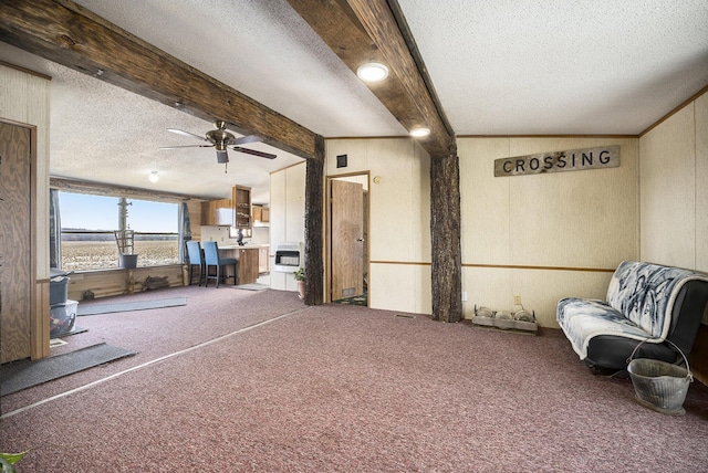 interior space with vaulted ceiling with beams, carpet floors, heating unit, and a textured ceiling