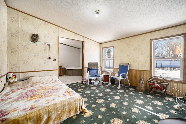 carpeted bedroom featuring crown molding, vaulted ceiling, and a textured ceiling