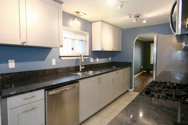 kitchen featuring white cabinetry, sink, dark stone countertops, and appliances with stainless steel finishes