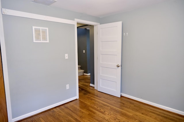 empty room with hardwood / wood-style floors