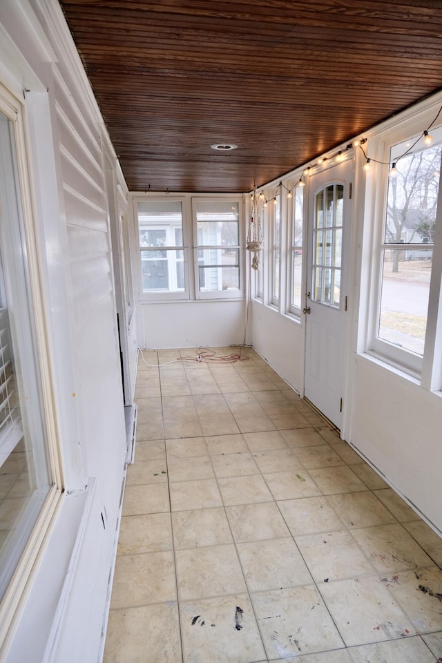 unfurnished sunroom featuring wooden ceiling