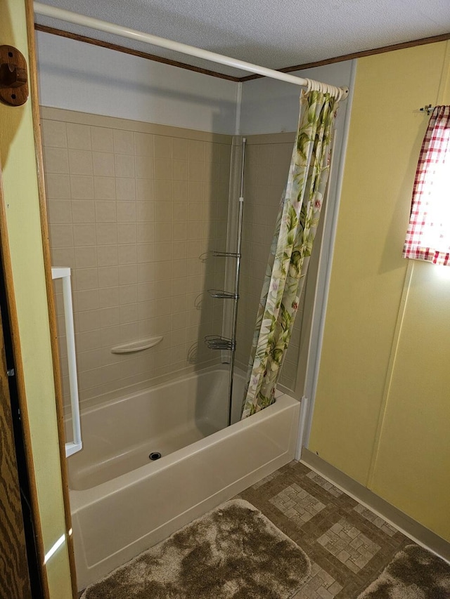 bathroom featuring shower / bath combination with curtain and a textured ceiling