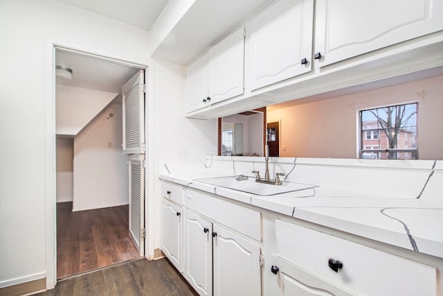 kitchen with sink, white cabinets, and dark hardwood / wood-style flooring