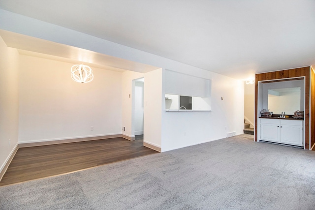 unfurnished living room with dark colored carpet