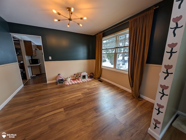 interior space featuring hardwood / wood-style floors and a notable chandelier