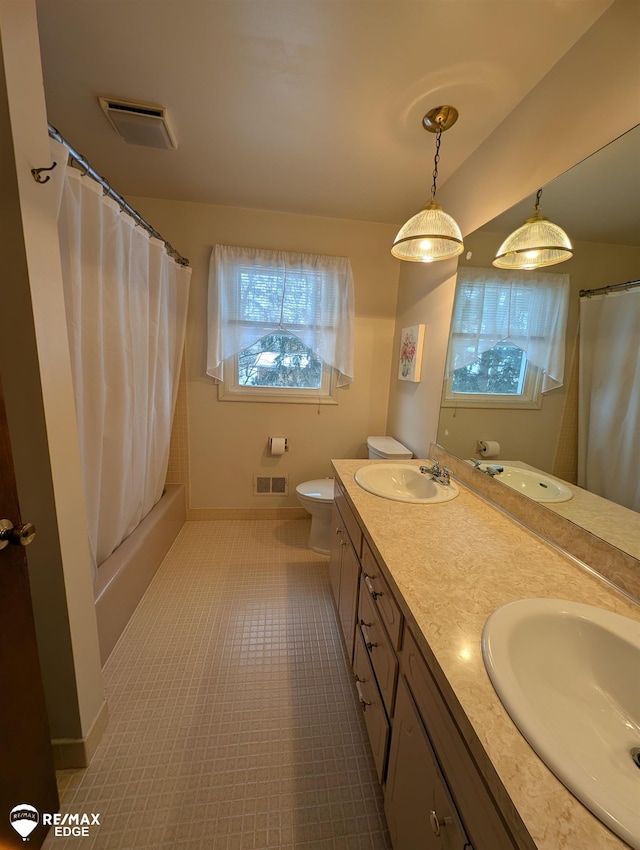 full bathroom with vanity, shower / bath combo with shower curtain, and toilet