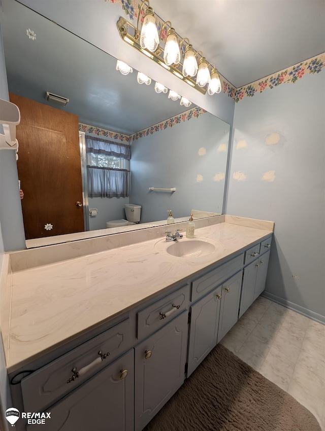 bathroom featuring vanity and toilet