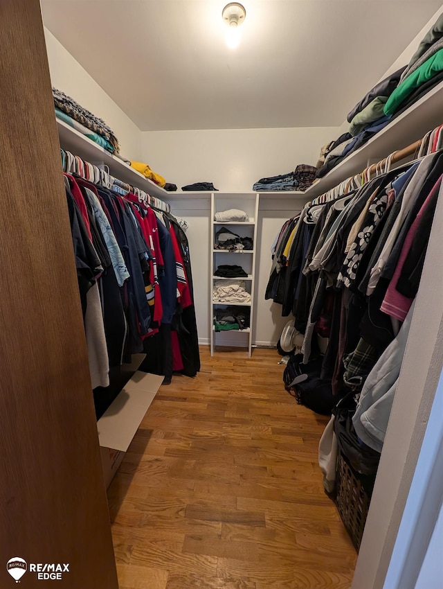 spacious closet with light hardwood / wood-style floors