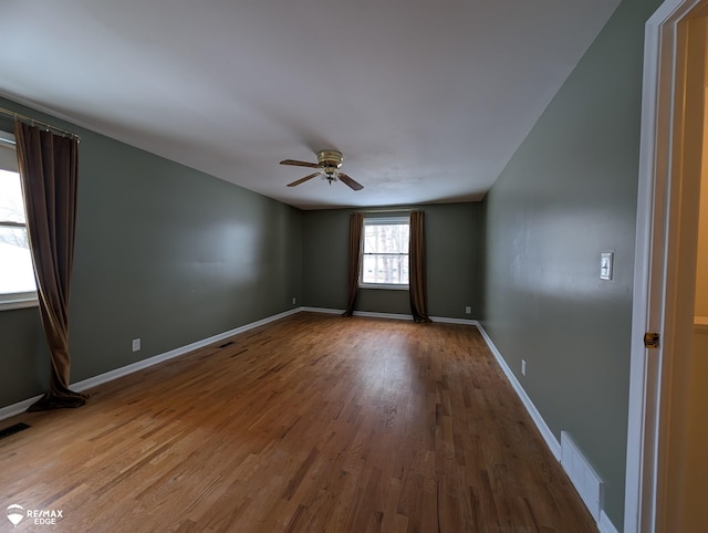 empty room with hardwood / wood-style flooring and ceiling fan