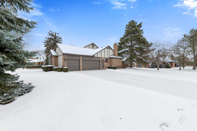 view of snow covered exterior with a garage