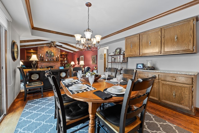 dining room with dark hardwood / wood-style flooring, crown molding, and lofted ceiling