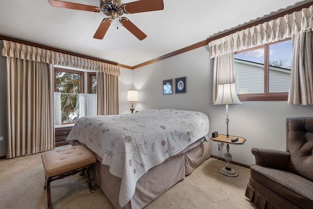 bedroom featuring crown molding, light carpet, and ceiling fan