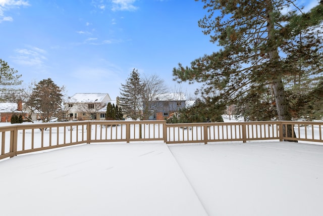 snow covered patio featuring a deck