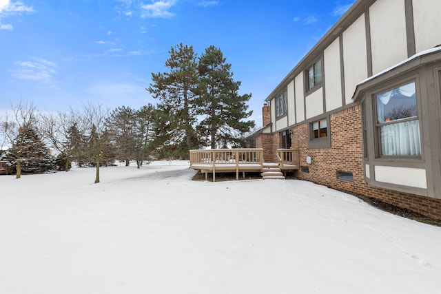 yard layered in snow with a wooden deck