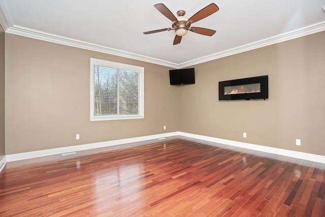 empty room featuring hardwood / wood-style flooring, ceiling fan, and ornamental molding