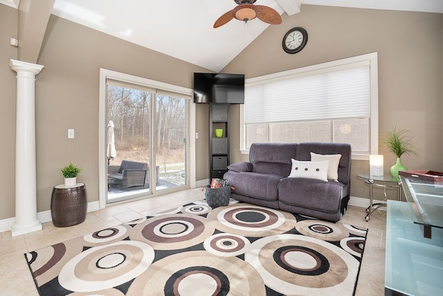 tiled living room featuring vaulted ceiling, ceiling fan, and decorative columns