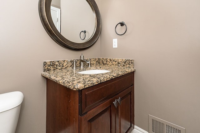 bathroom featuring vanity and toilet