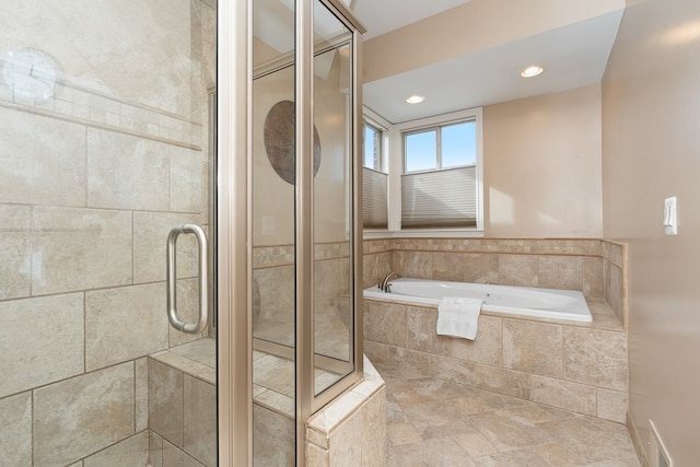 bathroom with separate shower and tub