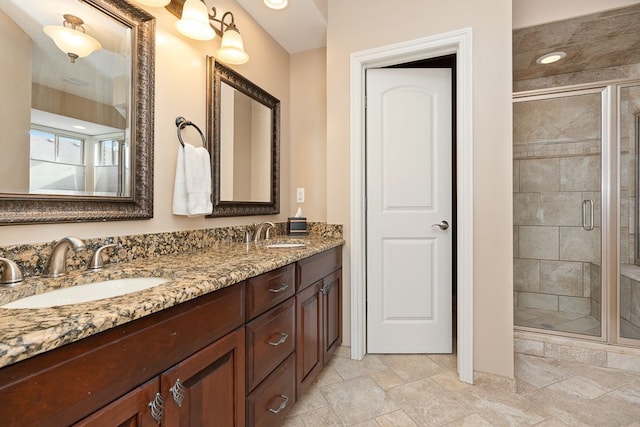 bathroom featuring vanity and a shower with shower door