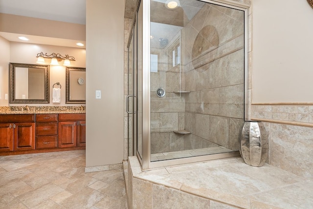 bathroom with vanity and a shower with door