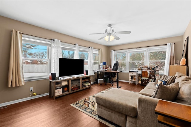 living room featuring dark hardwood / wood-style floors and ceiling fan