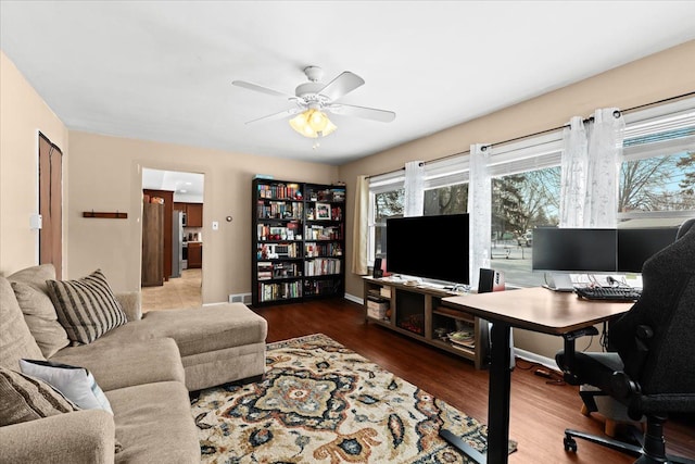 home office with wood-type flooring and ceiling fan