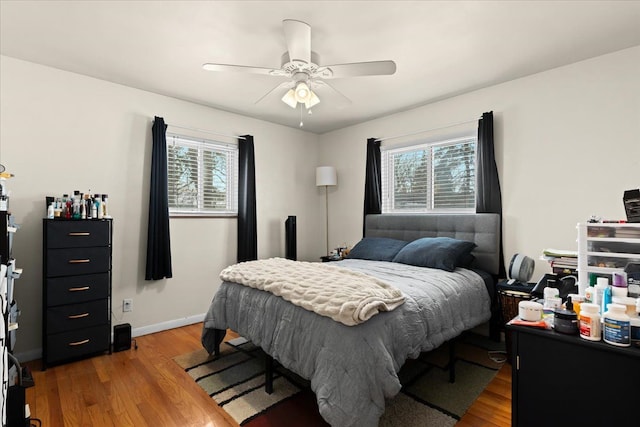 bedroom with ceiling fan and hardwood / wood-style floors