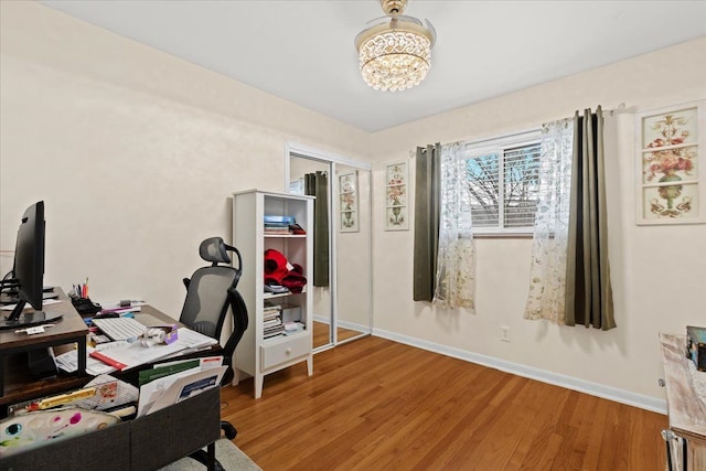 office space featuring hardwood / wood-style floors and a notable chandelier