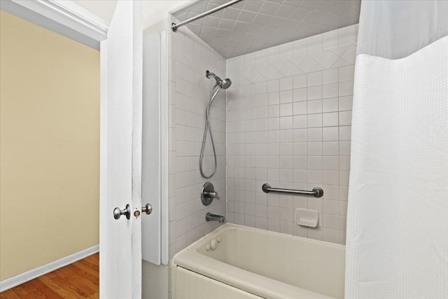 bathroom with shower / tub combo with curtain and wood-type flooring