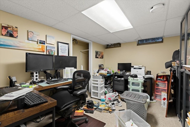 home office with a paneled ceiling and carpet floors