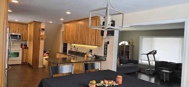 kitchen featuring pendant lighting, a breakfast bar area, kitchen peninsula, and white range with electric cooktop