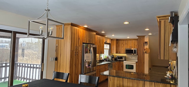 kitchen with a breakfast bar, sink, decorative light fixtures, kitchen peninsula, and stainless steel appliances