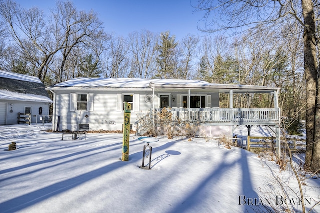 snow covered house with covered porch