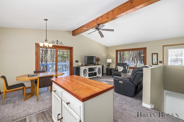 kitchen with hanging light fixtures, plenty of natural light, and white cabinets