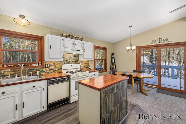 kitchen featuring vaulted ceiling, decorative light fixtures, white cabinetry, sink, and white appliances