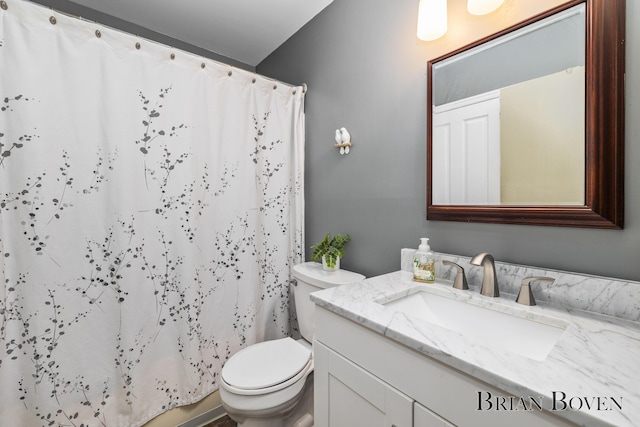 bathroom with vanity, a shower with shower curtain, and toilet