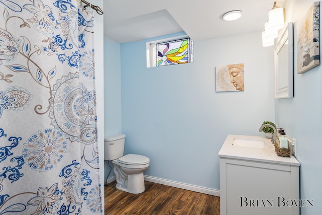 bathroom featuring hardwood / wood-style flooring, vanity, and toilet