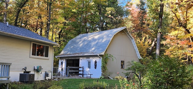 exterior space featuring a yard and central AC