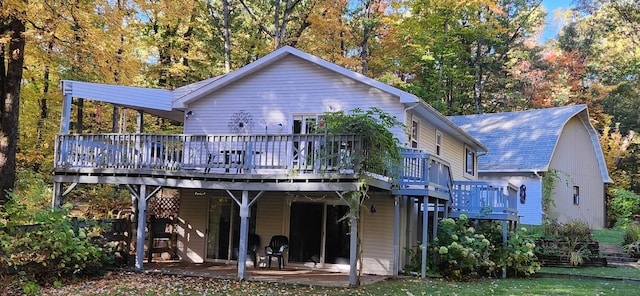 back of house featuring a patio and a deck