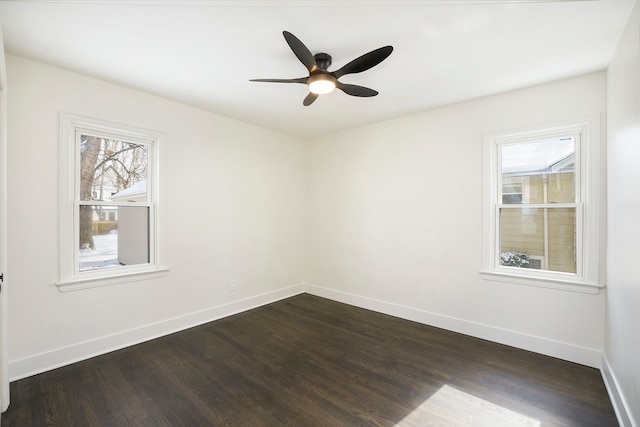 spare room with dark hardwood / wood-style floors and ceiling fan