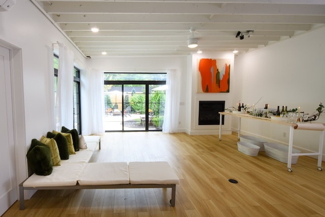 living room featuring hardwood / wood-style floors and beam ceiling