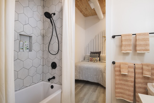 bathroom featuring hardwood / wood-style flooring and shower / bath combination with curtain