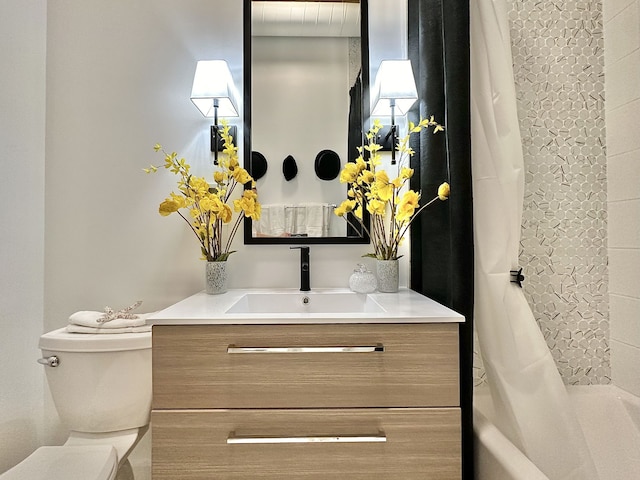 full bathroom with vanity, shower / bath combination with curtain, and toilet