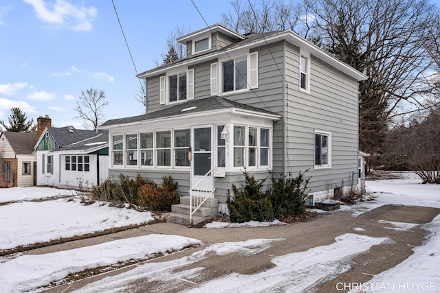 view of front property with a sunroom