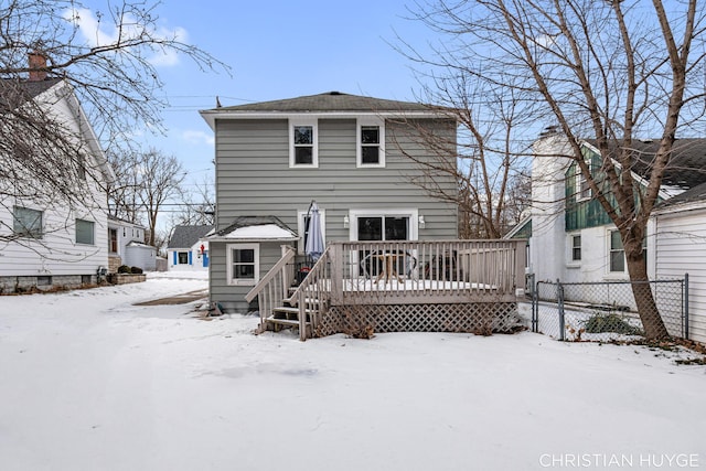 snow covered property with a deck