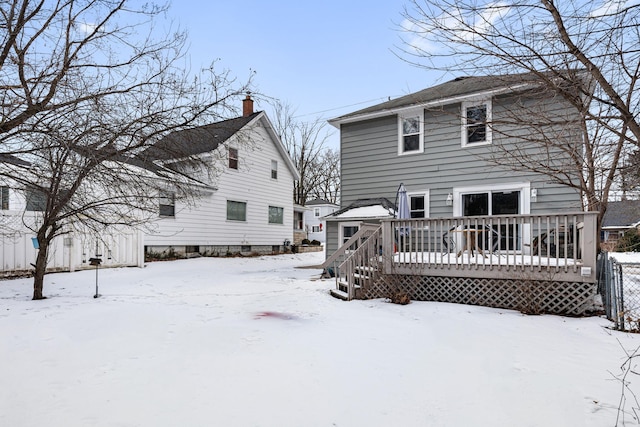 snow covered property with a wooden deck