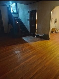 interior space featuring arched walkways and wood finished floors