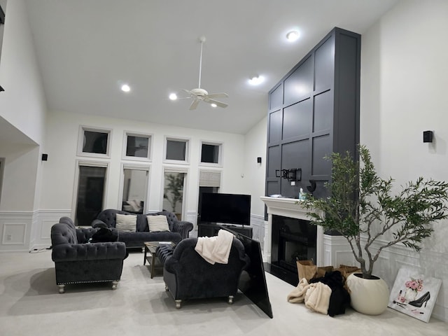 living room with ceiling fan and high vaulted ceiling