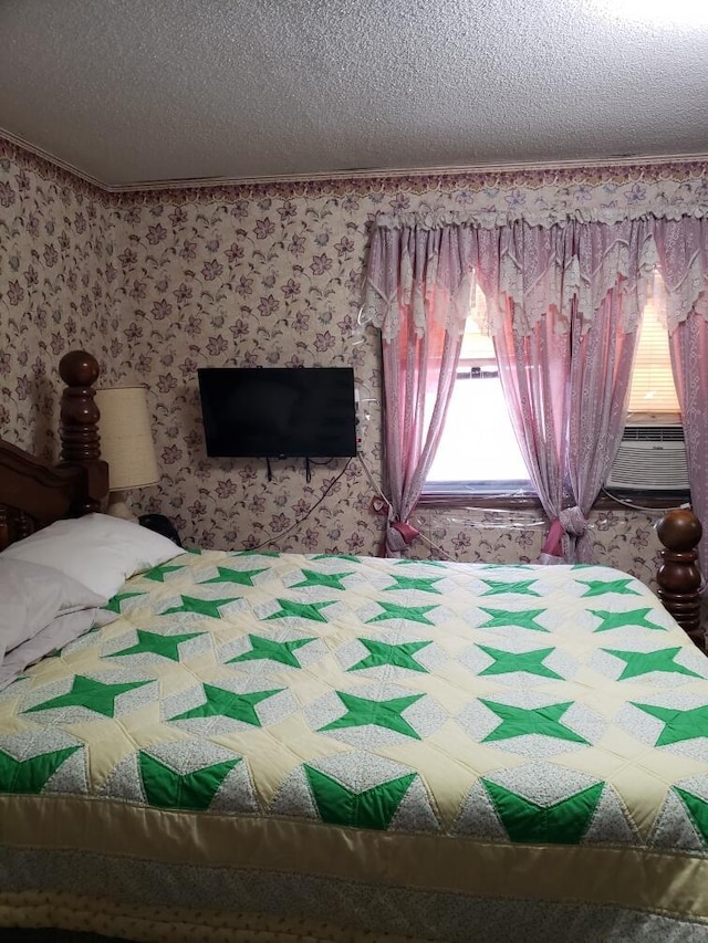 bedroom with a textured ceiling and cooling unit